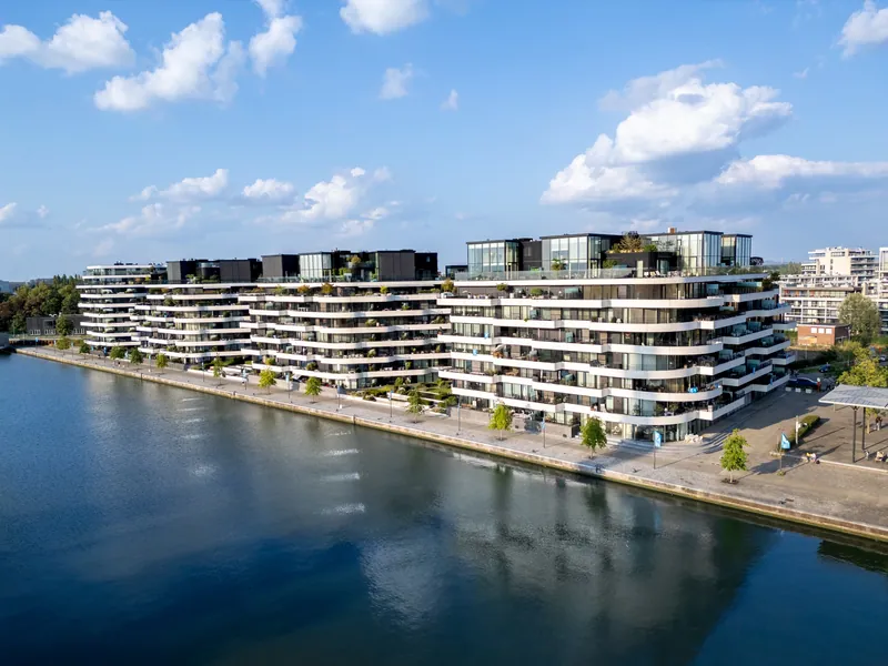 Luchtbeeld van de gebogen gebouwen van Quartier Bleu aan de Kanaalkom